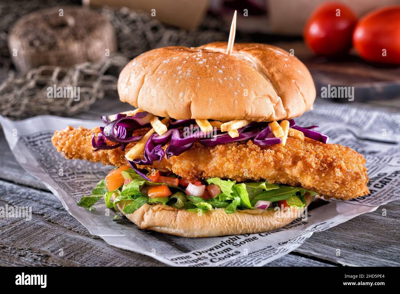 A delicious ultimate fish burger deluxe with breaded fish, lettuce