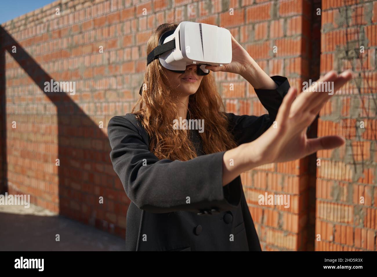 Female using augmented reality glasses on building site Stock Photo