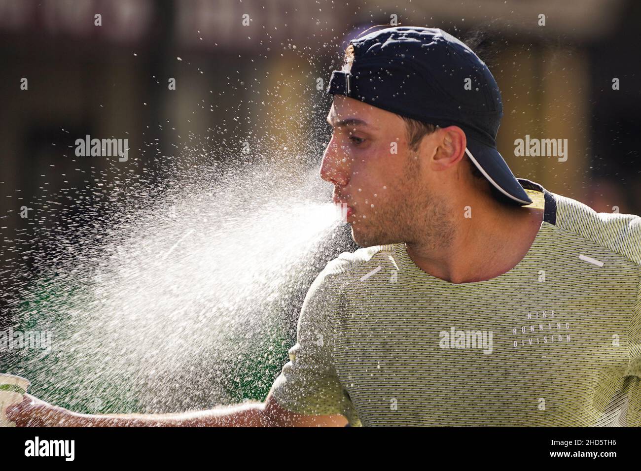 New York, USA. Nov 7th, 2021. A runner spits out water while passing by ...