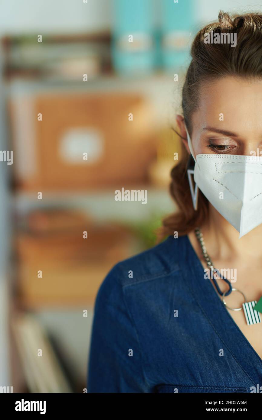middle aged small business owner woman with ffp2 mask in the office. Stock Photo