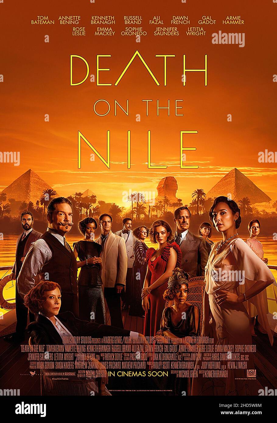 DEATH ON THE NILE, poster, from left: Russell Brand, Kenneth Branagh as Hercule Poirot, Annette Bening (seated), Letitia Wright, Tom Bateman, Ali Fazal, Jennifer Saunders, Emma Mackey, Sophie Okonedo (seated), Armie Hammer, Dawn French, Gal Gadot, Rose Leslie, 2022. © 20th Century Studios / Courtesy Everett Collection Stock Photo