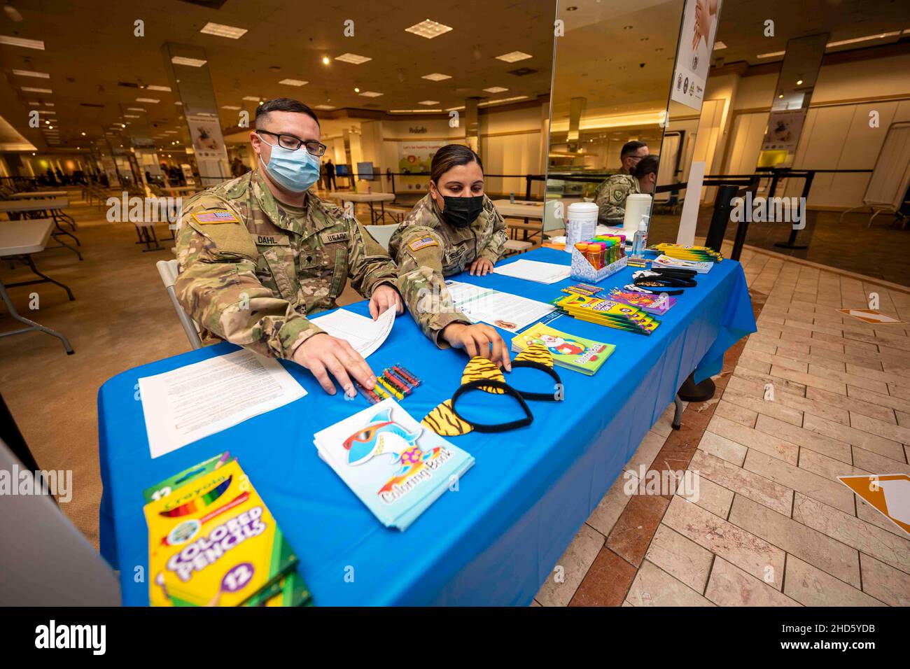 Bridgewater, New Jersey, USA. 15th Dec, 2021. U.S. Army Spc. Kris Dahl, left, and Sgt. Jessica Dejesus, with the 154th Water Company, 42nd Regional Support Group, organize a children's section at the COVID-19 vaccination mega-site in Bridgewater, N.J., Dec. 16, 2021. The New Jersey National Guard has over 40 Soldiers at the mega-site assisting with temperature screening, registering and guiding individuals through the various stations, as well as monitoring people after they received their vaccinations. Credit: U.S. Army/ZUMA Press Wire Service/ZUMAPRESS.com/Alamy Live News Stock Photo