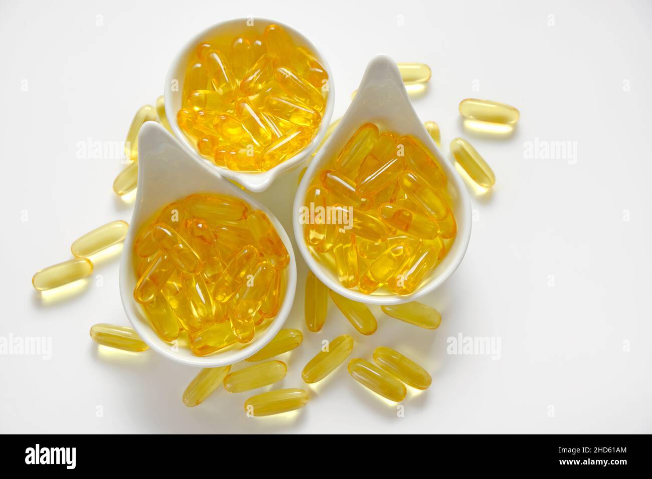 Fish oil.omega 3 gelatin capsules in white ceramic cups .omega fatty