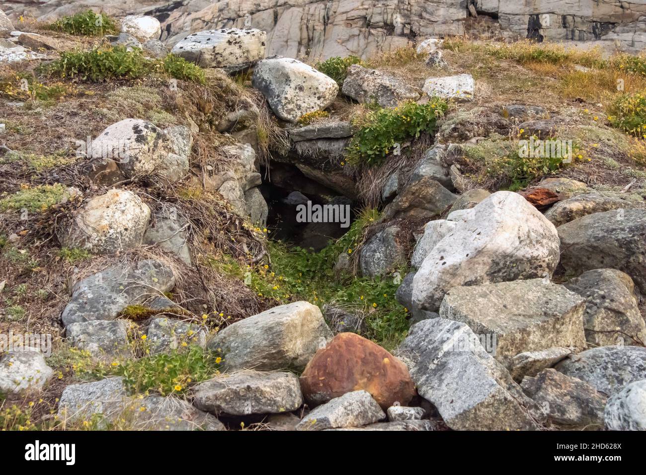 Remains of a Thule winter house with below ground entrance, Danmark O, Scoresby Sund, East Greenland Stock Photo