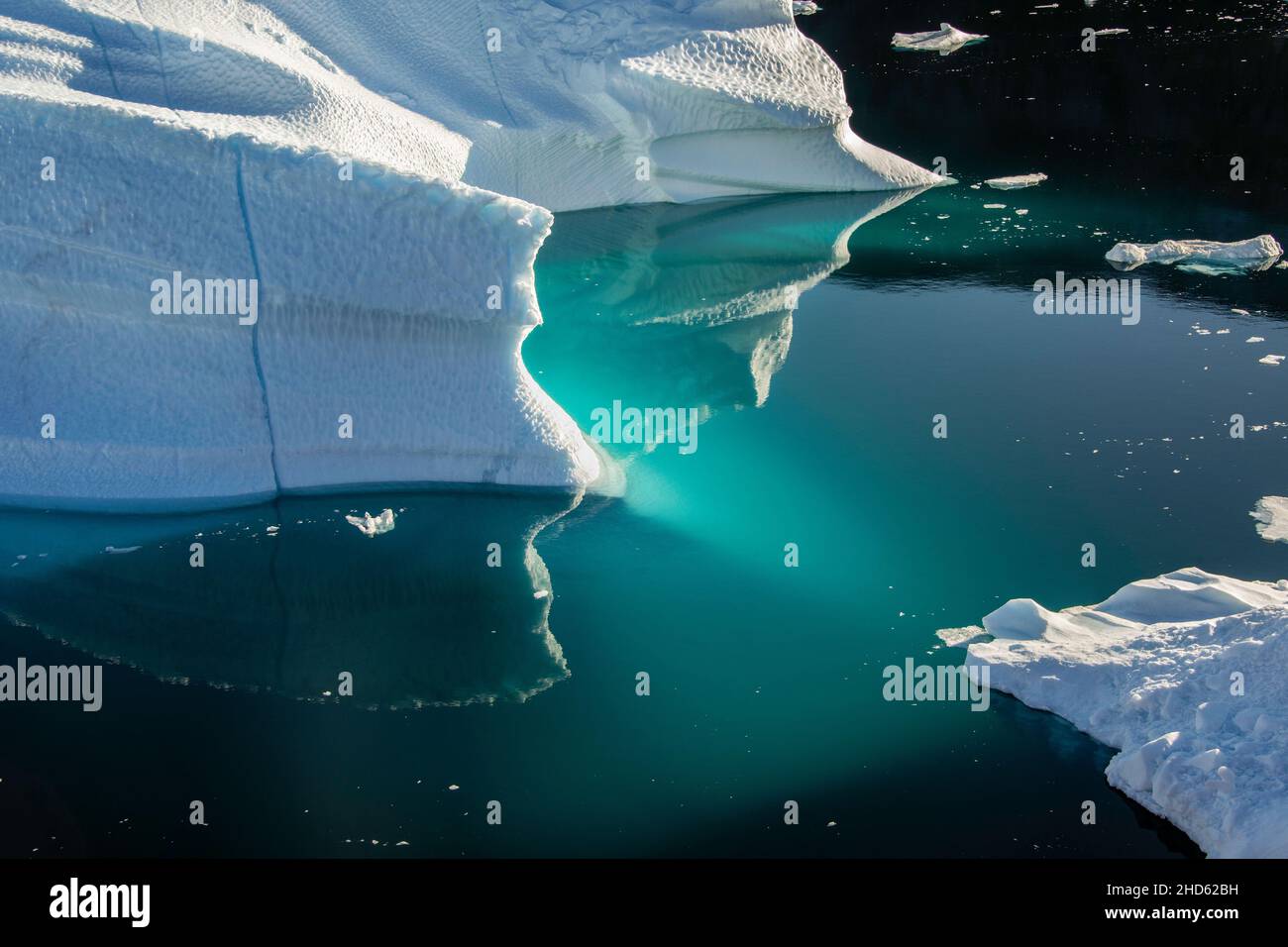 Water near an iceberg with luminescent blues and greens, Rodefjord, Scoresby Sund, Greenland Stock Photo