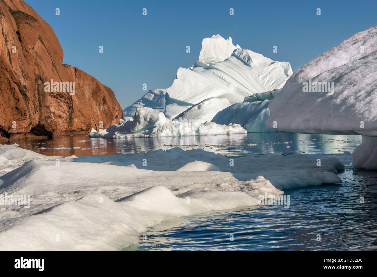 Icebergs piled up in the strait between Rode O and Milne Land, Rodefjord, Scoresby Sund, Greenland Stock Photo