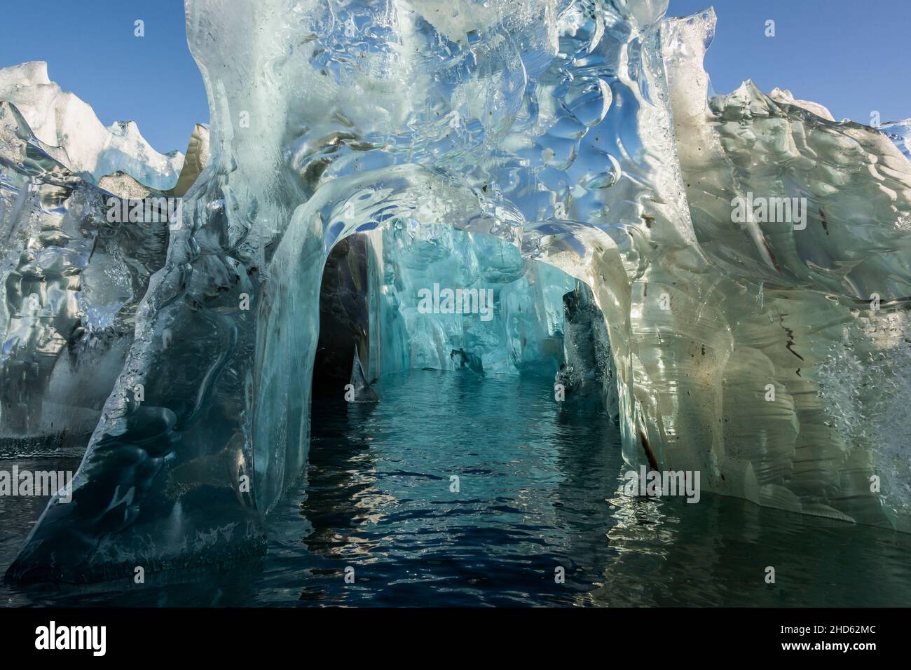 Looking into an ice cave in an old crystalline blue iceberg, Rodefjord, Scorseby Sund, East Greenland Stock Photo