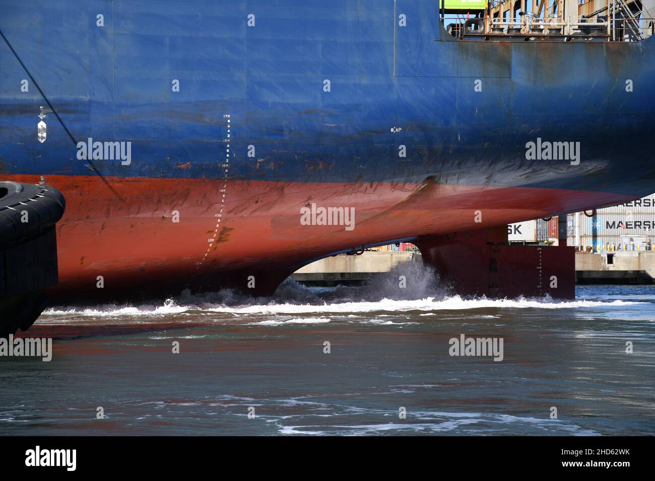 Tugs docking container ship APL President Eisenhower, Port of Oakland. Commercial freight and container ships in San Francisco Bay, California Stock Photo