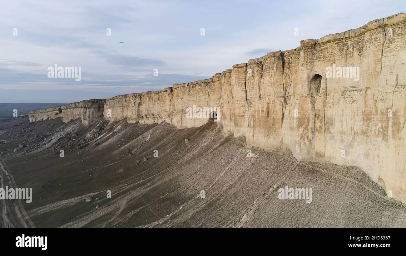 Aerial for breathtaking white cliff near green valley on beautiful