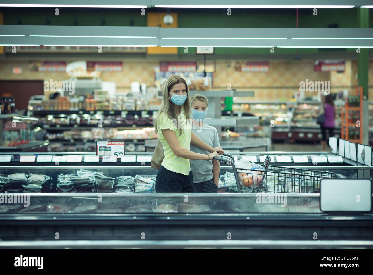 Chicago, IL- August 21, 2021:Mother and a child wearing protective masks, shopping at a grocery store, for editorial use only Stock Photo