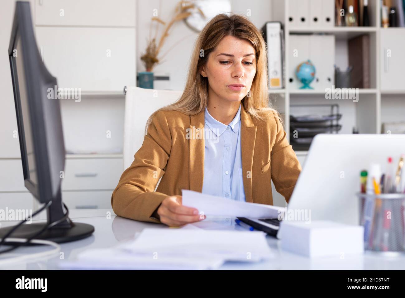 adult businesswoman working in her white office Stock Photo - Alamy