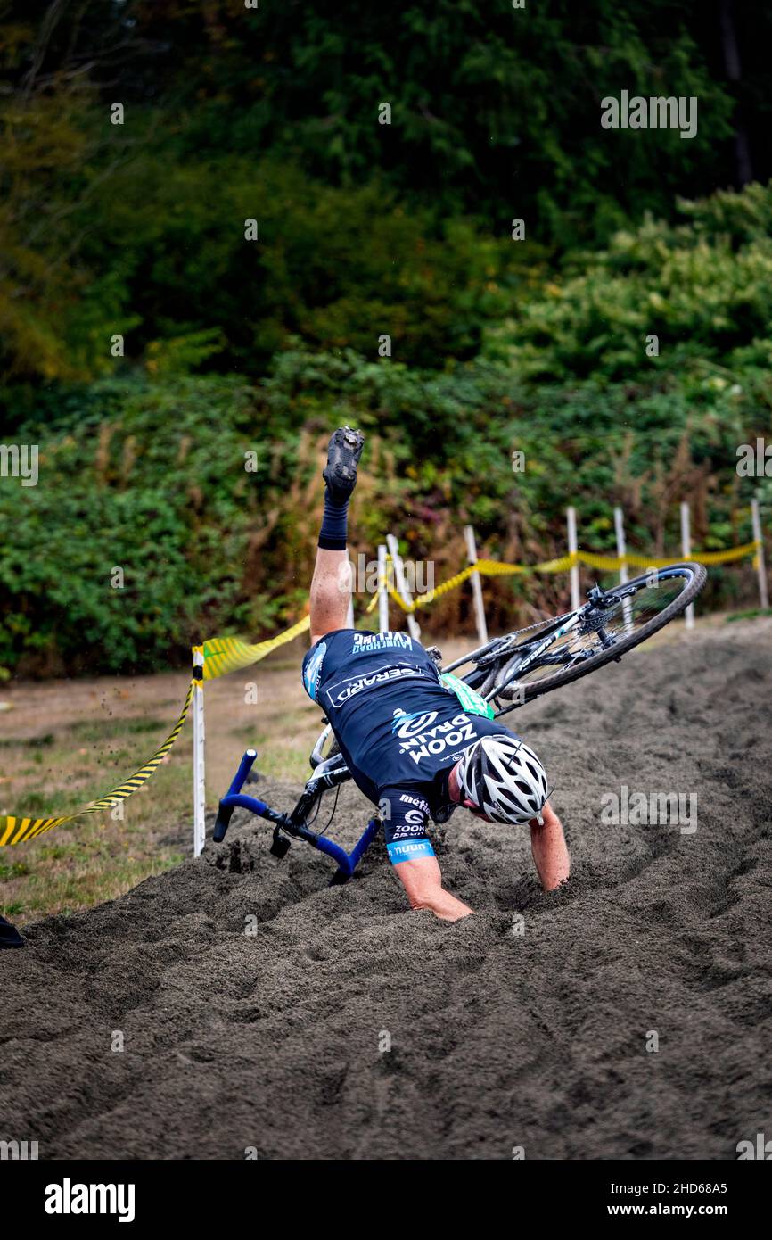 WA20581-00....WASHINGTON - Cyclist takes a spill in the sand pit during a men's cyclocross race takes a spill. Stock Photo