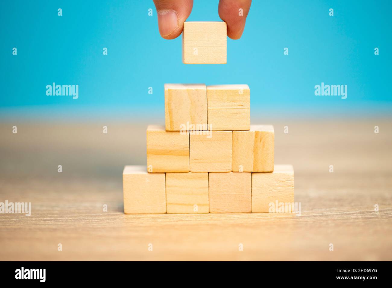Hand holding a wooden block letter e, put on the meaning of the word