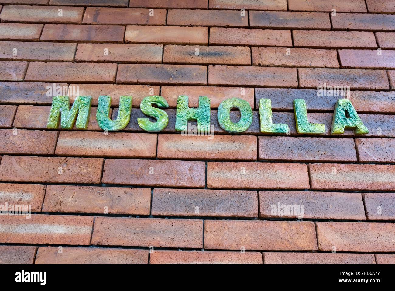 a wall with sign place 'Musholla' , prayer room for muslims Stock Photo