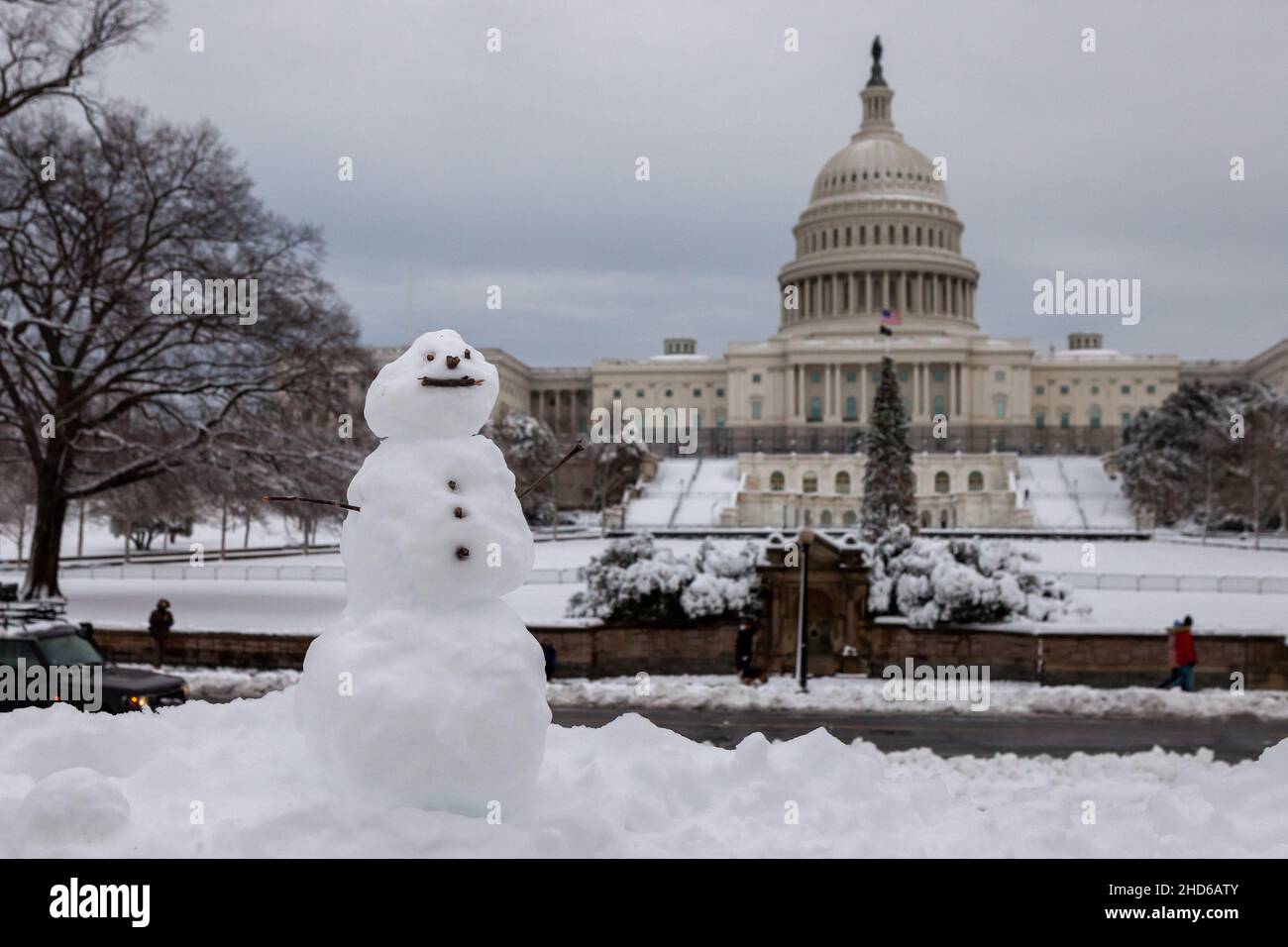 Washington, DC, USA, 3 January 2022.  Pictured: A tiny snowman sits on a railing at the US Capitol after an unexpected snowstorm dumped roughly 8 inches on snow on Washington, DC.  Credit: Allison Bailey / Alamy Live News Stock Photo