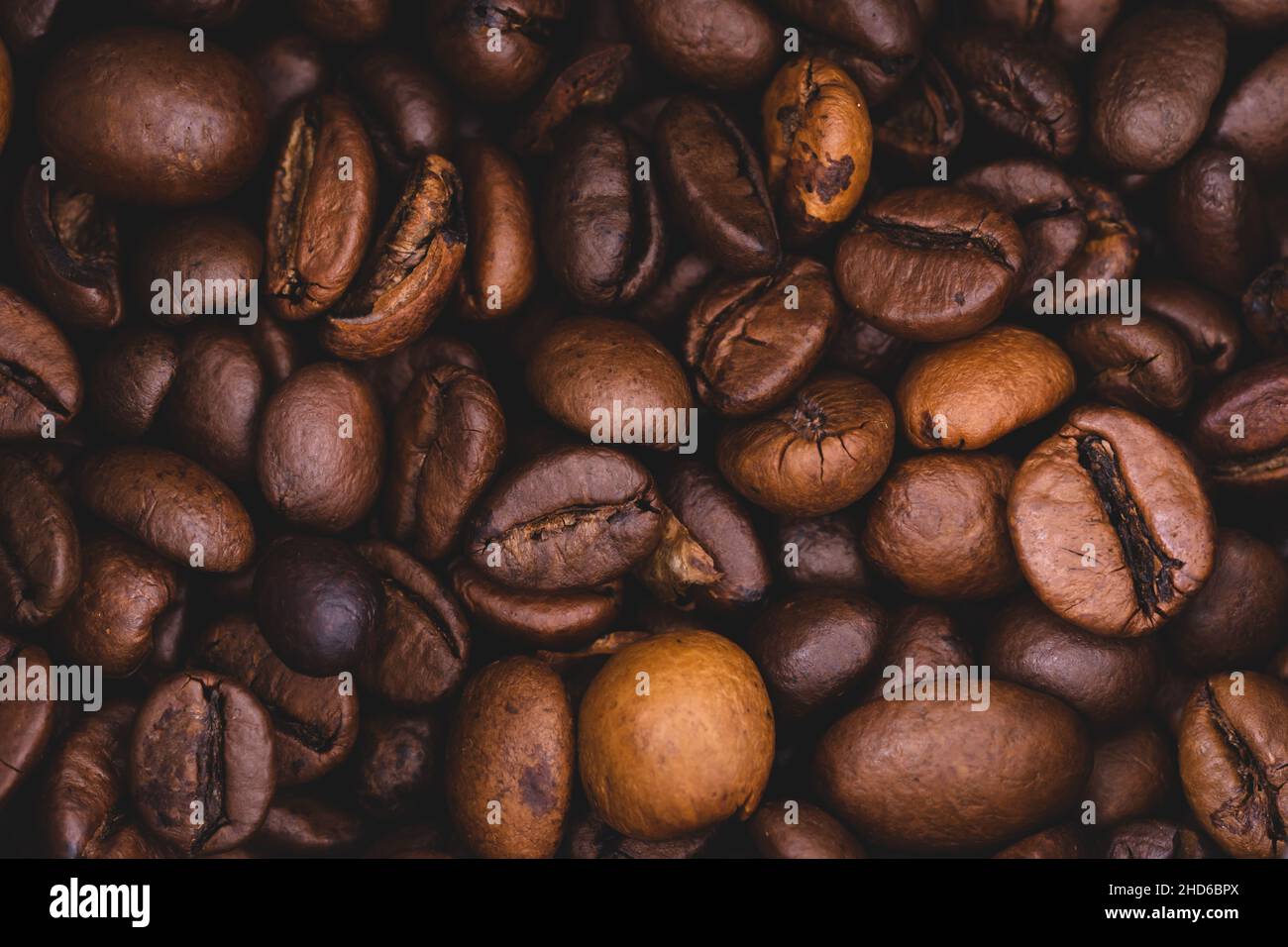 Roasted coffee beans full frame background Close up macro dark brown Stock Photo