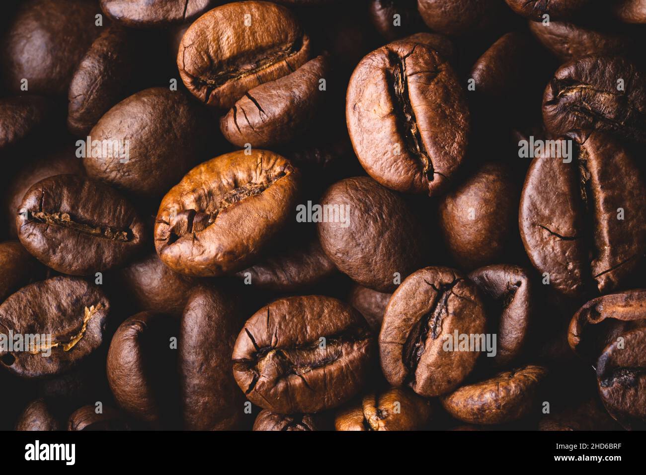 Roasted coffee beans full frame background Close up macro dark brown Stock Photo