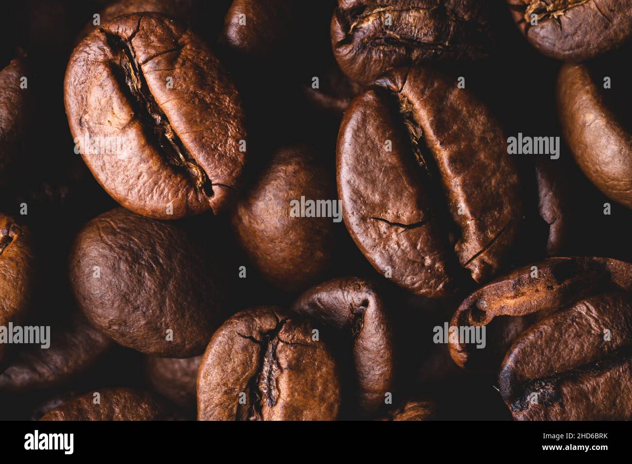 Roasted coffee beans full frame background Close up macro dark brown Stock Photo