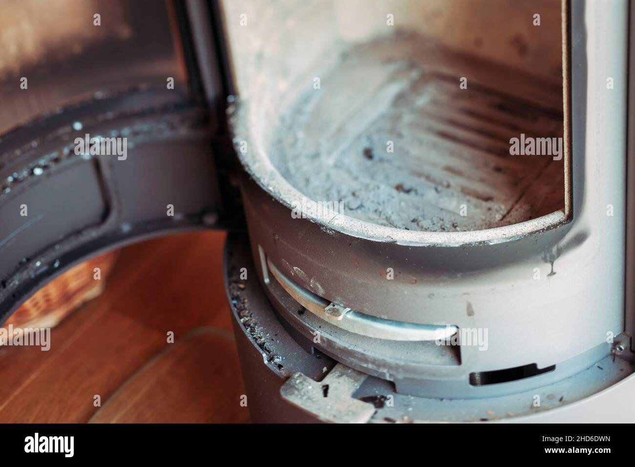Empty wood burning stove with open door after removing ash Stock Photo