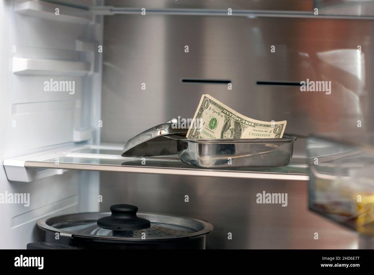 one dollar bill inside a fridge, concept of no money left for shopping Stock Photo