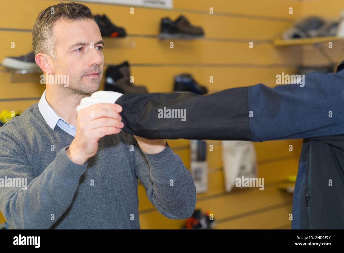 boutique vendor changing mannequins clothing Stock Photo Alamy