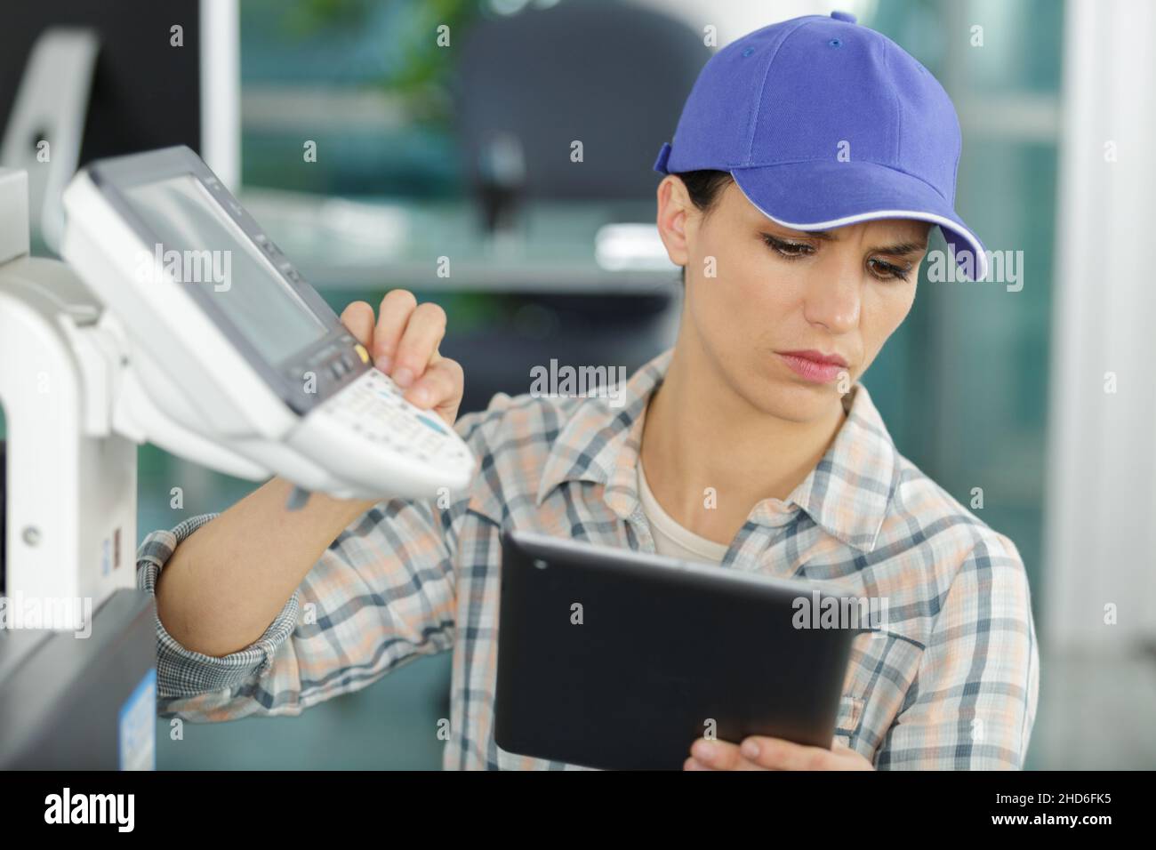 young craftswoman fixing a printer Stock Photo