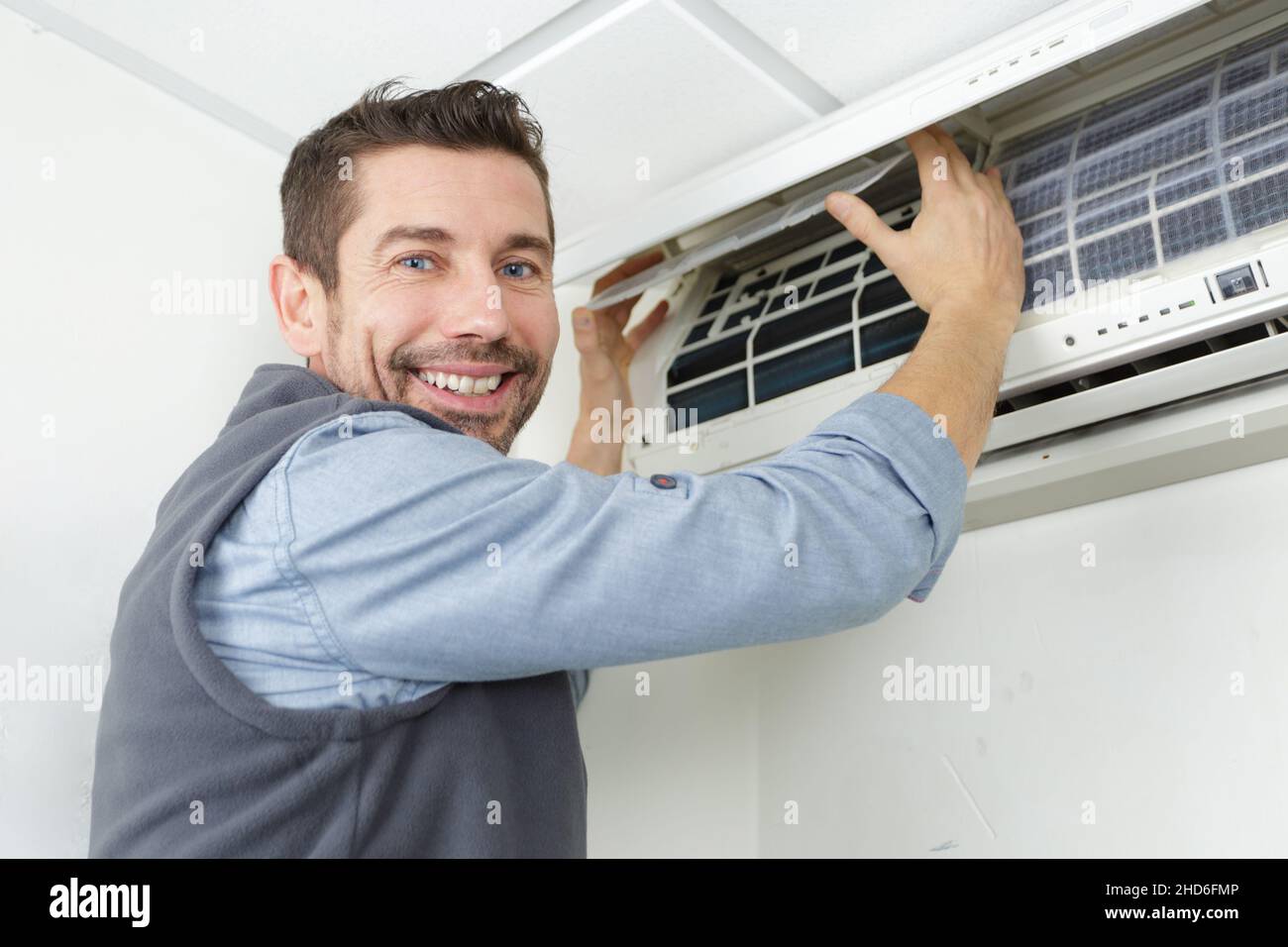 male repairman connecting air conditioner pipes Stock Photo Alamy