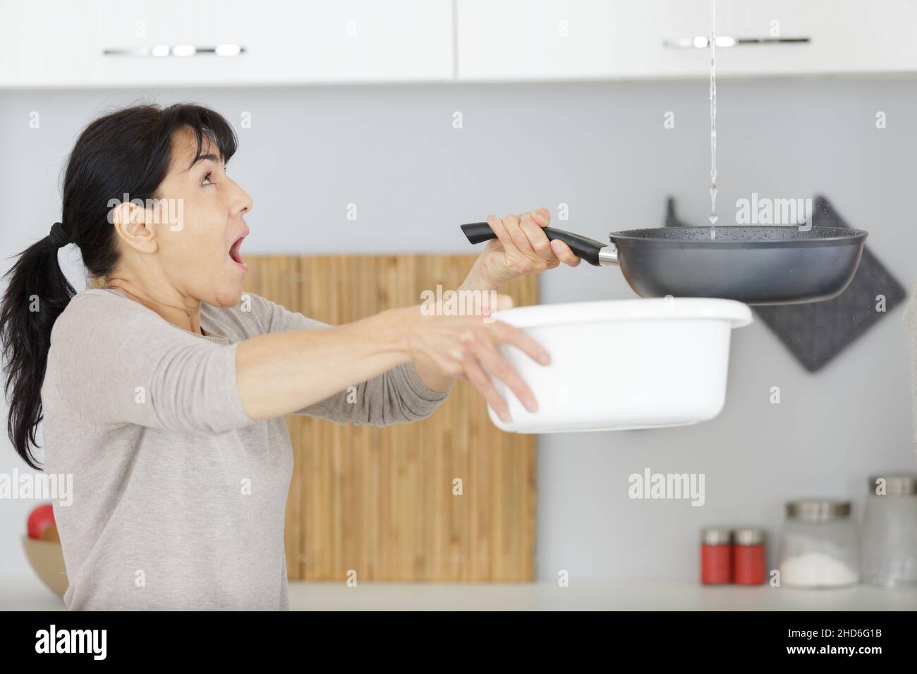 Woman leaking ceiling phone hi-res stock photography and images - Alamy
