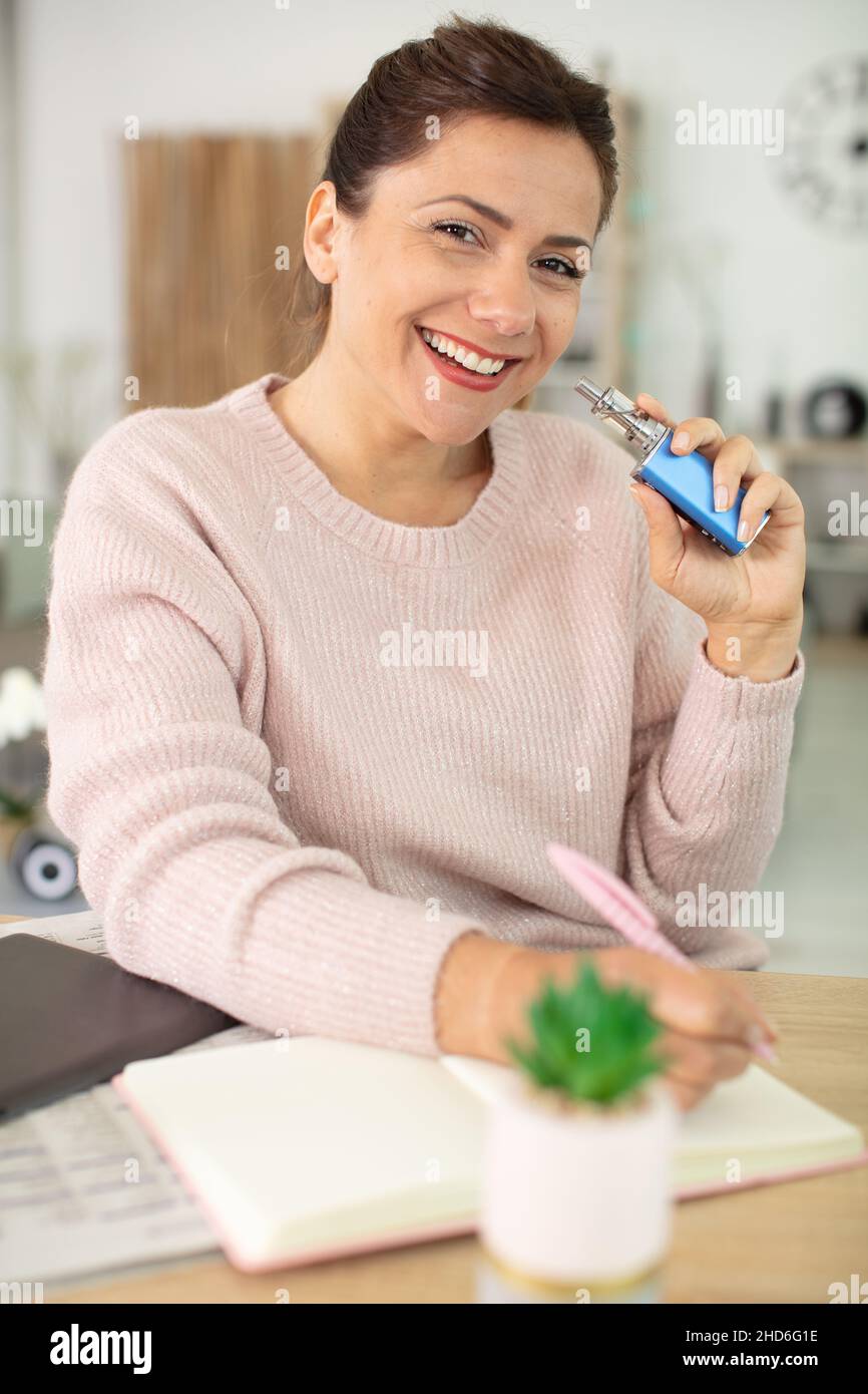 woman vaping enjoying an electronic cigarette Stock Photo