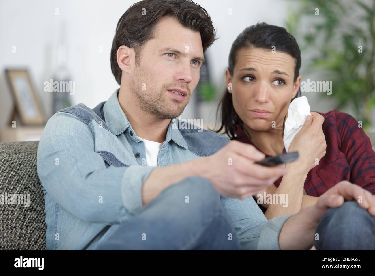 two sad friends crying watching tv Stock Photo