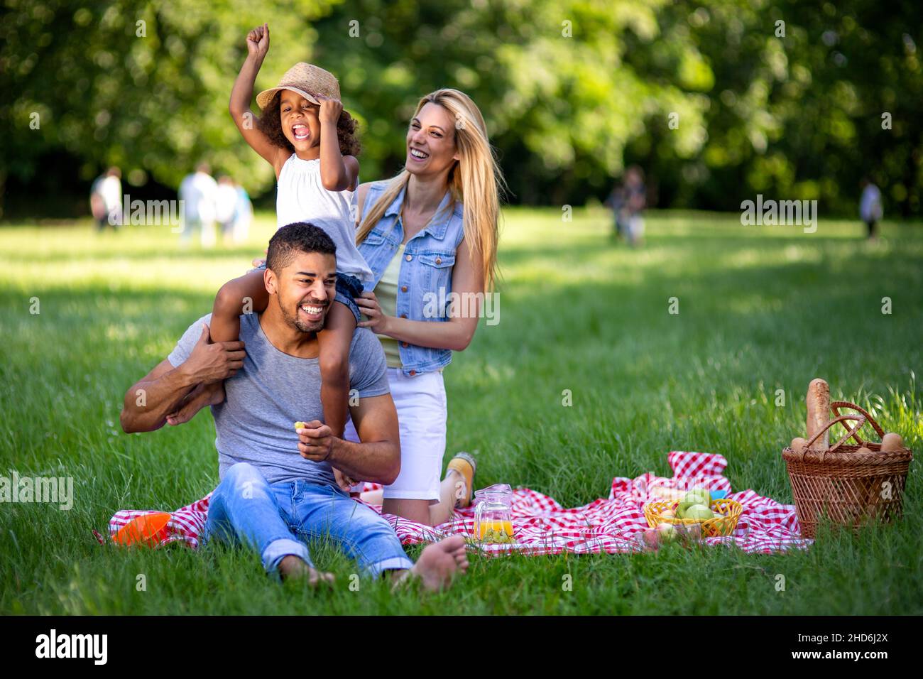 Happy multiethnic family enjoying picnic in nature Stock Photo