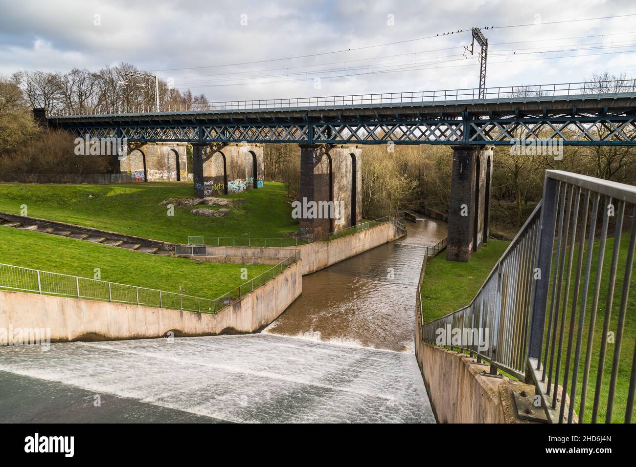 Water flowing down Carr Mill Dam towards Sankey Valley Park on the