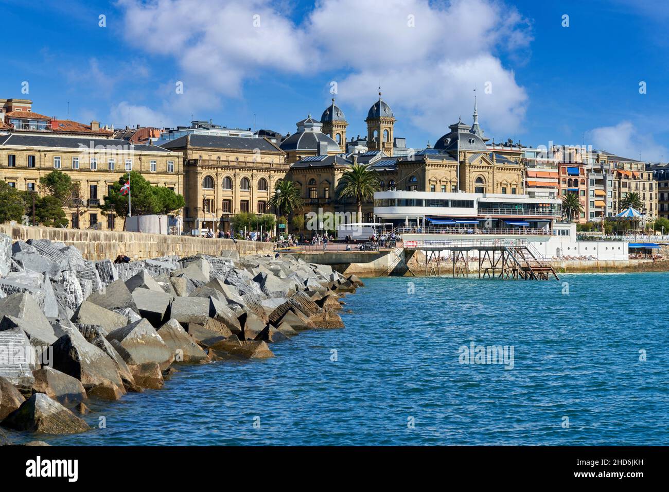 Breakwater of the old Fishing Port and now recreational, In the background the building of the Nautical Club and the Town Hall, Bahia de La Concha, Stock Photo
