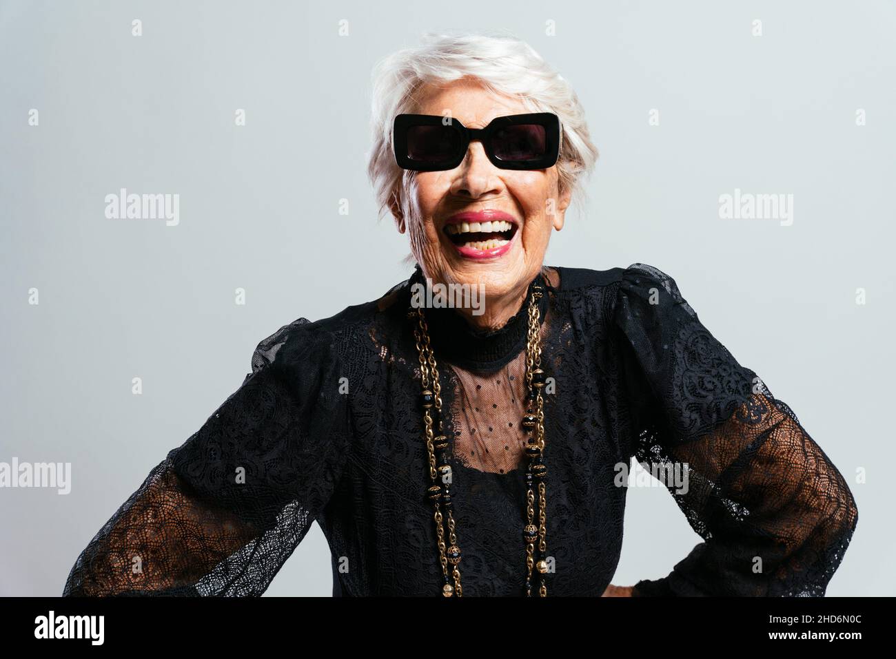 Beautiful and elegant old influencer woman. Cool grandmother posing in ...