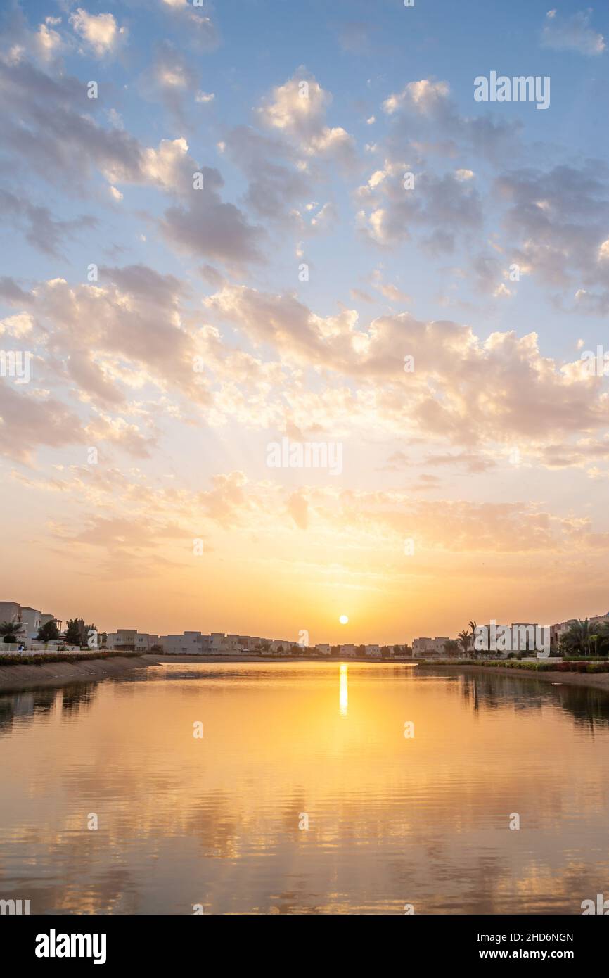 Sunset over a lake at Emirates Hills in Dubai in the United Arab Emirates. Stock Photo