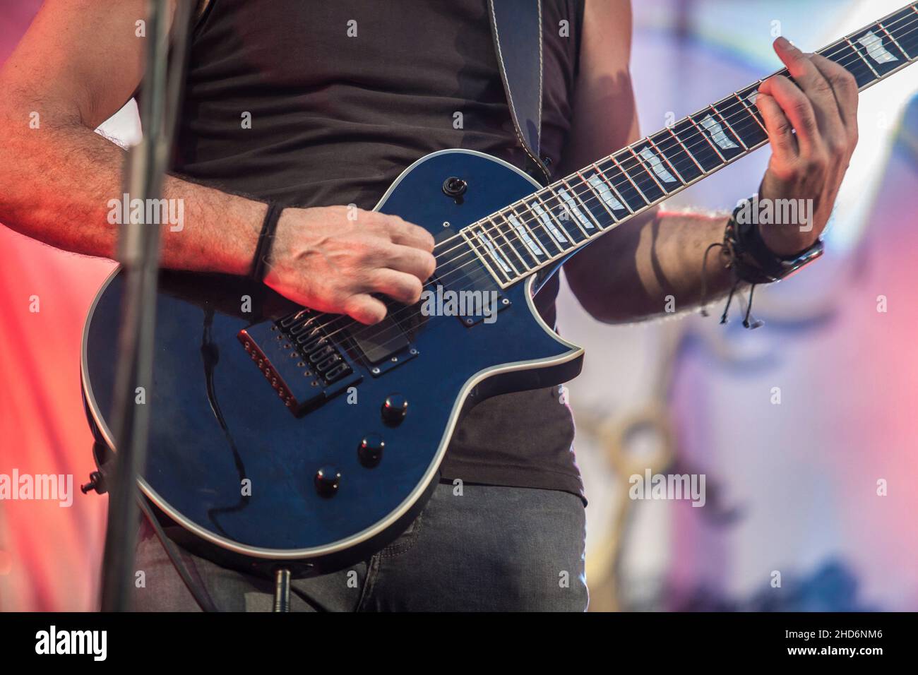 Hard rock musicians performing. Guitar player. Stock Photo