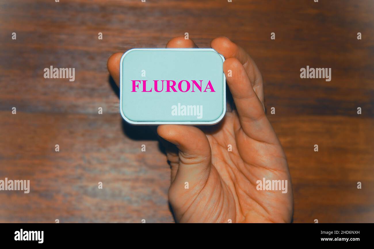 Doctor hand holding a banner with text 'Flurona' concept new strain or variant of Covid19 Stock Photo