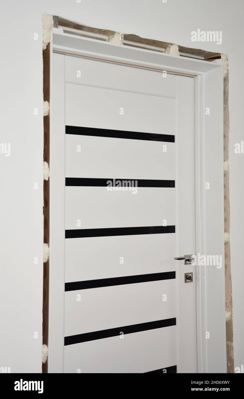 Interior door installation Fixing and installing a door jamb, door frame filling the gaps with