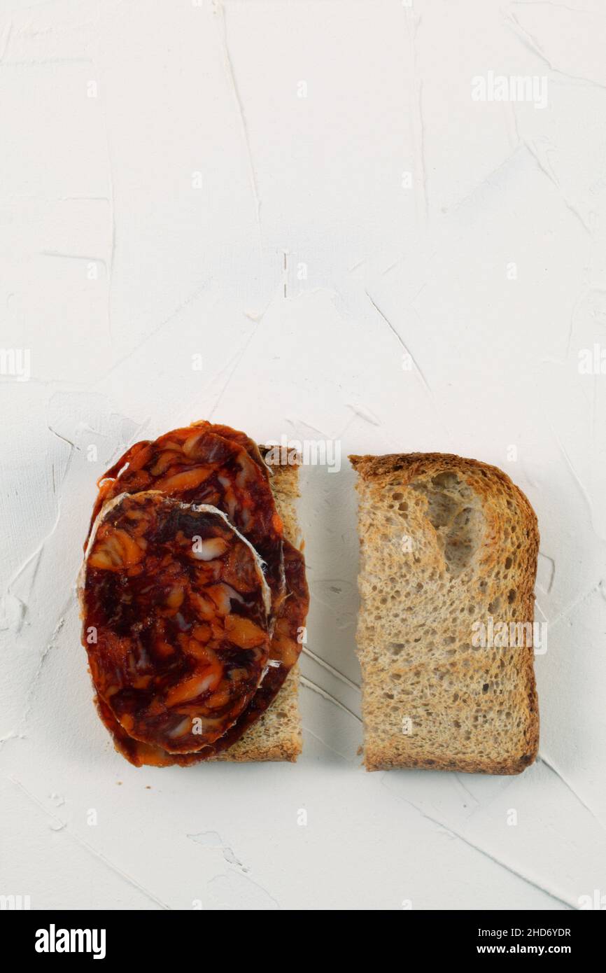 Sliced whole wheat bread with pork sausage. Stock Photo