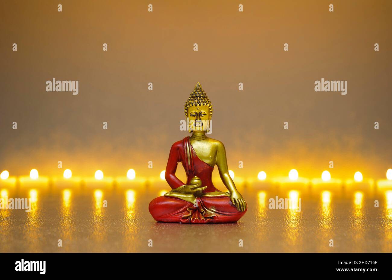 Japanese ZEN garden with candle lights and Buddha sculpture Stock Photo