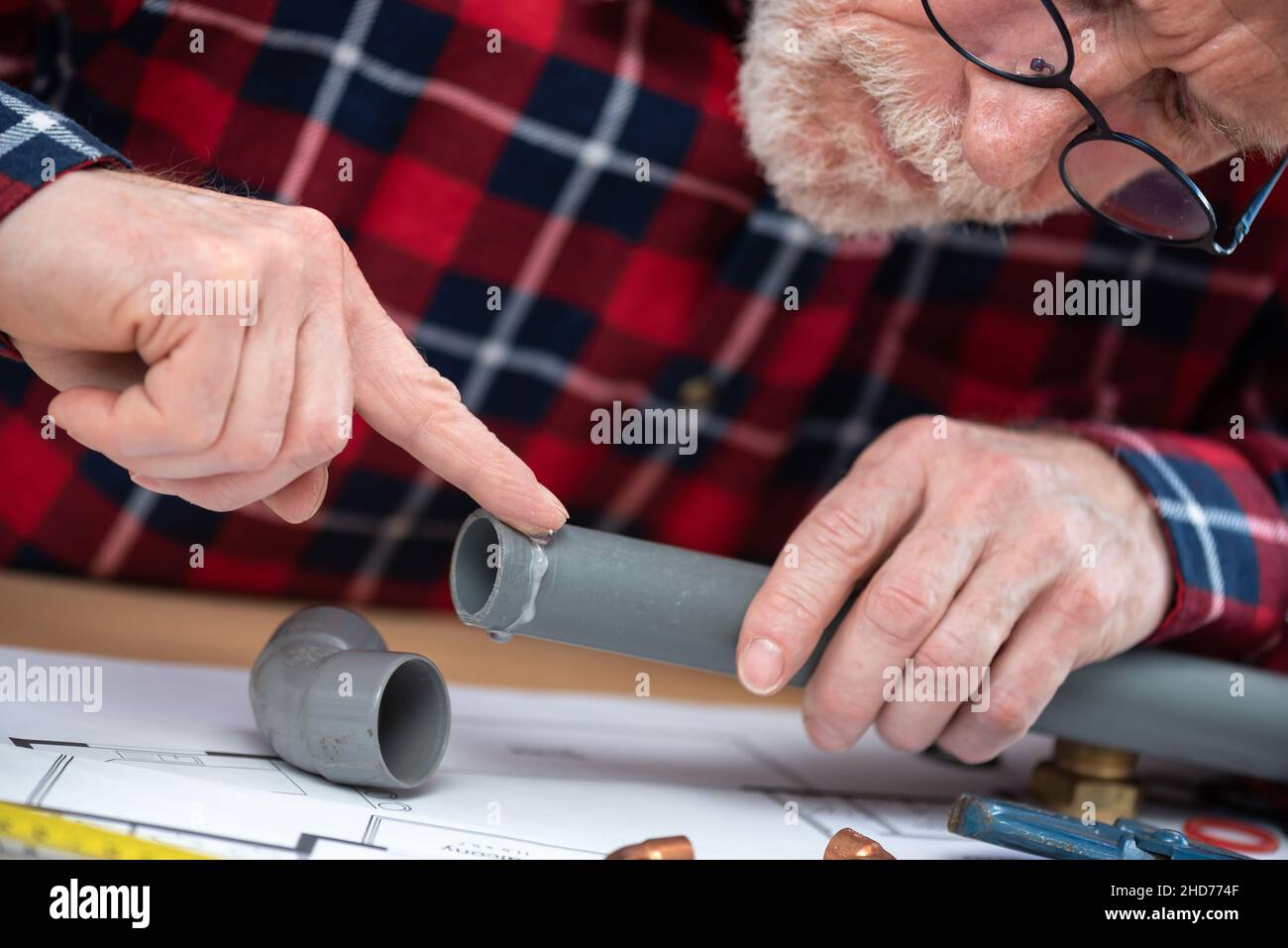 Plumber putting glue on a pvc pipe Stock Photo Alamy