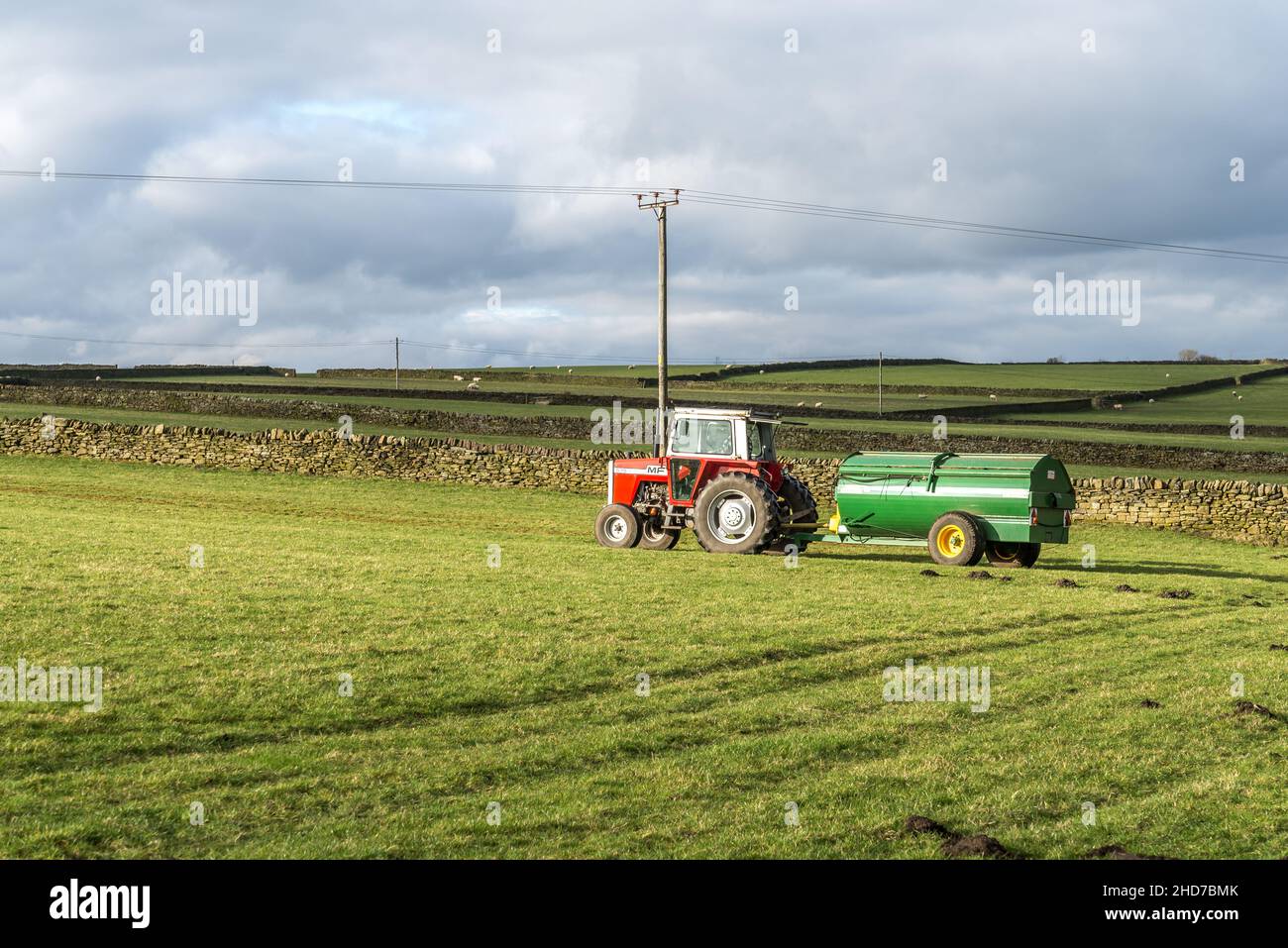Tractor Muck spreading on a field, Huddersfield, West Yorkshire, England, UK, Stock Photo