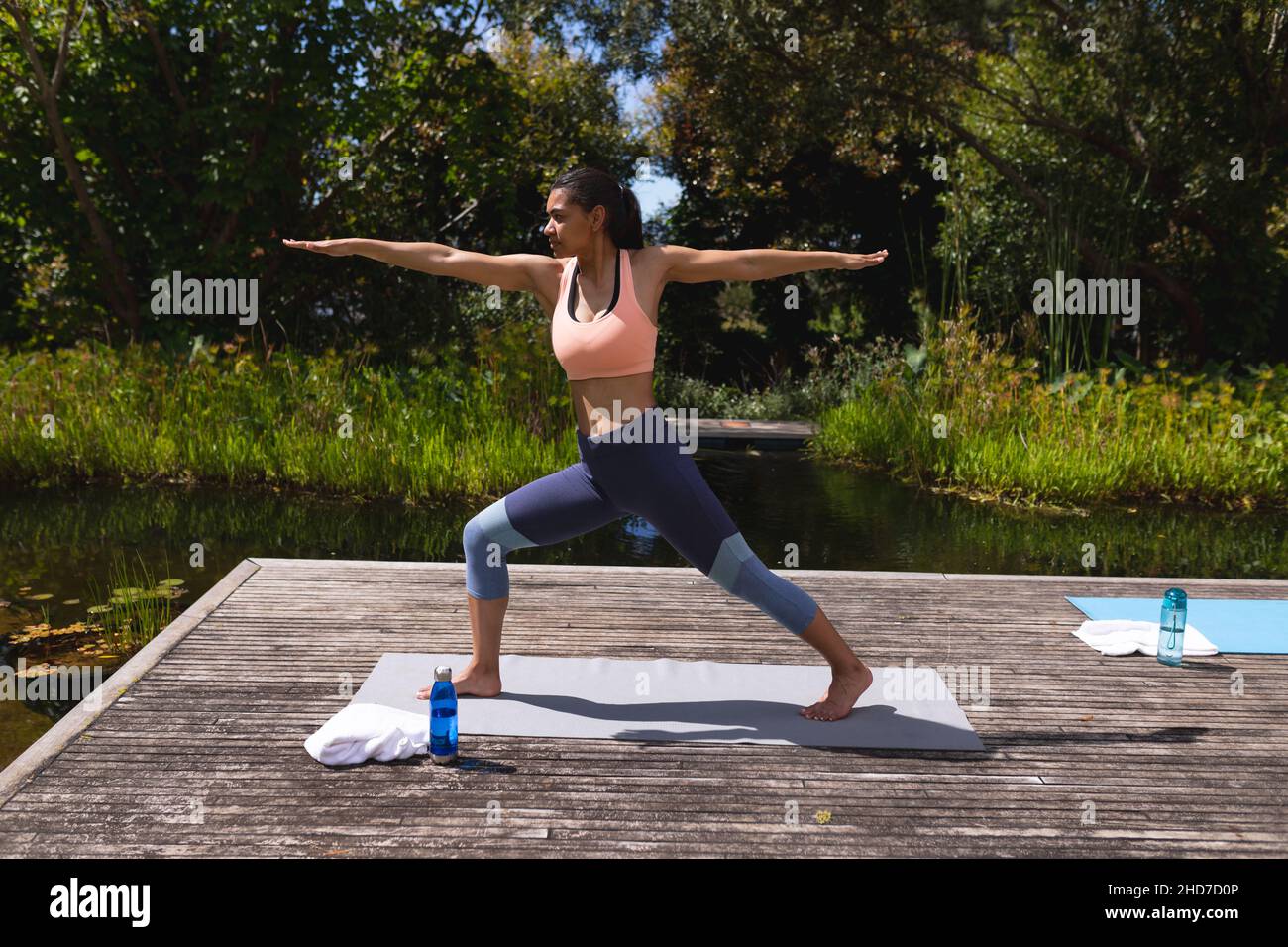 Full length of young woman in sportswear practicing yoga in park Stock Photo