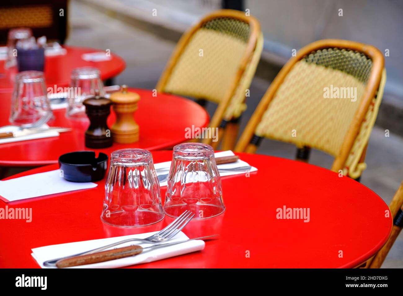 french restaurant - red tables with glasses and chairs on the street - Paris, France Stock Photo