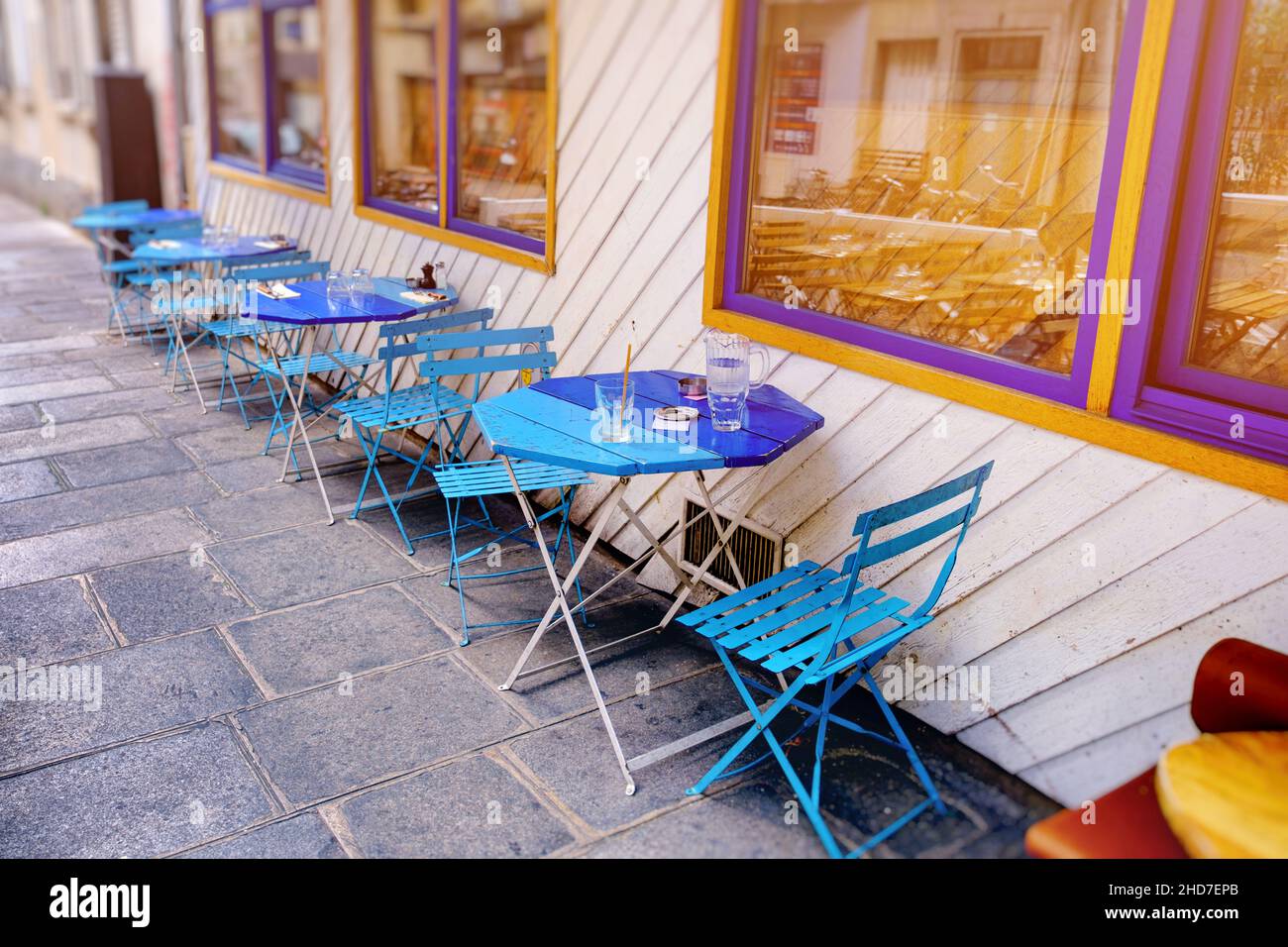 french restaurant - tables and chairs in the row on the street - Paris, France Stock Photo