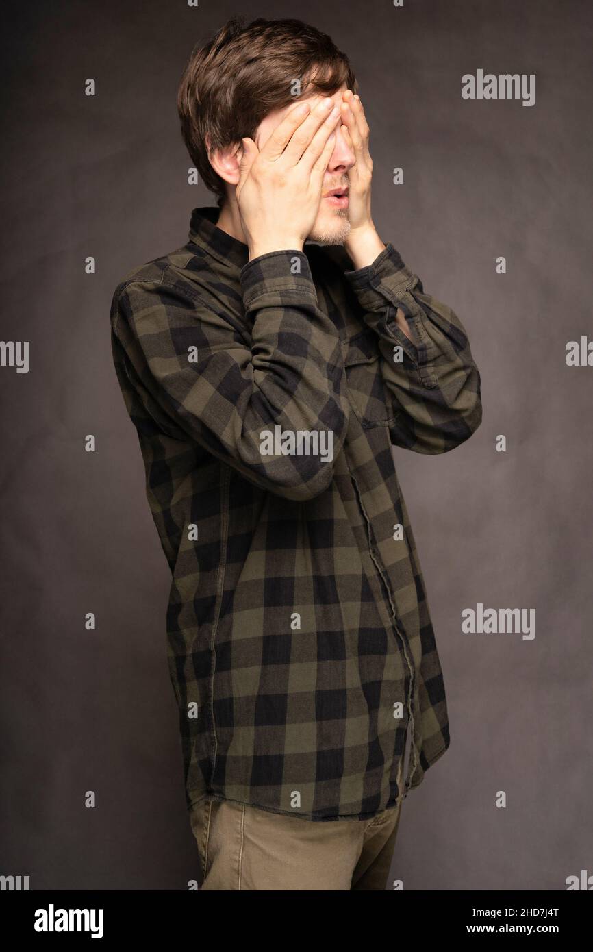 Young handsome tall slim white man with brown hair covering both eyes