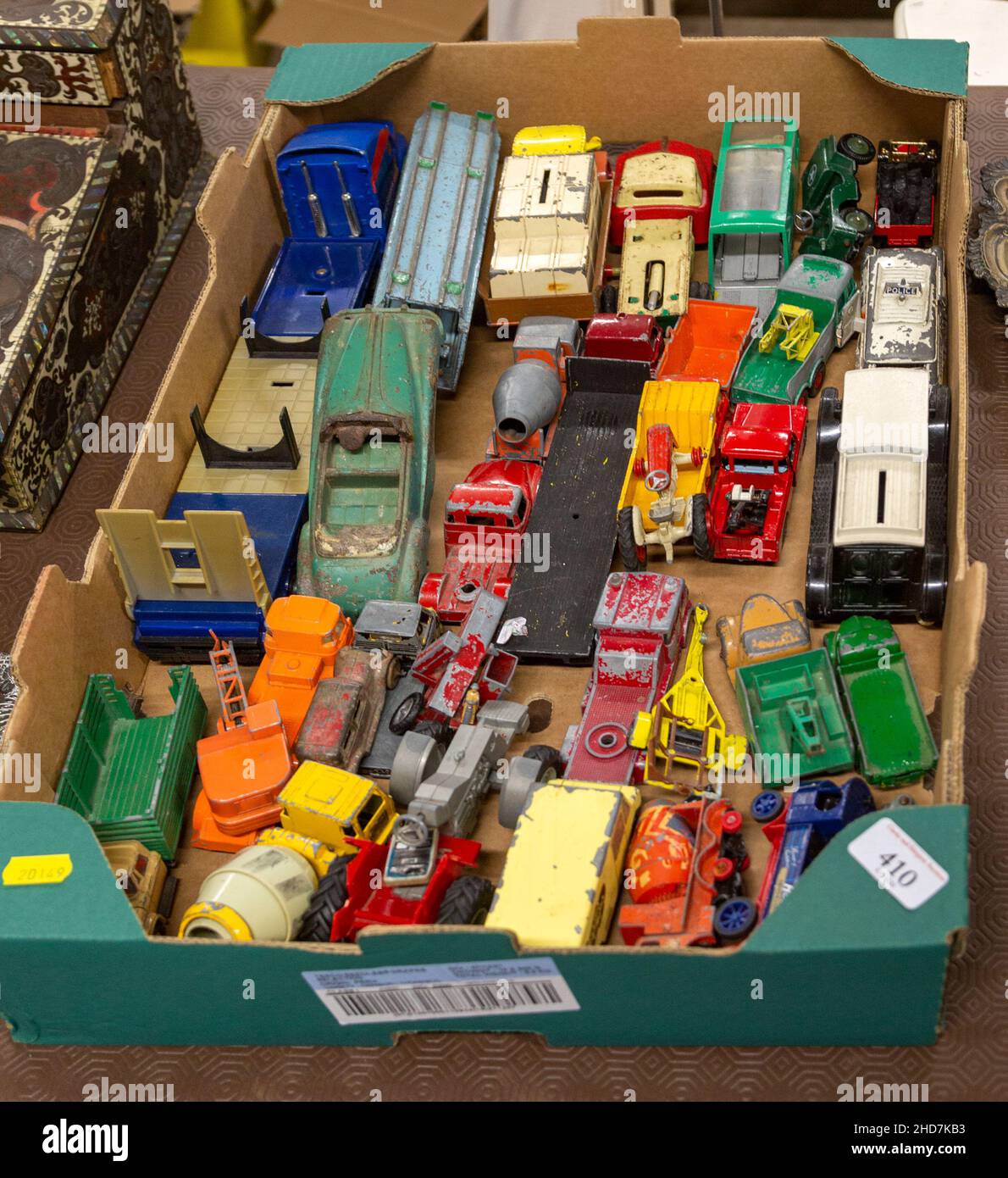 Box of old children's metal vehicles toys on display at auction Stock Photo