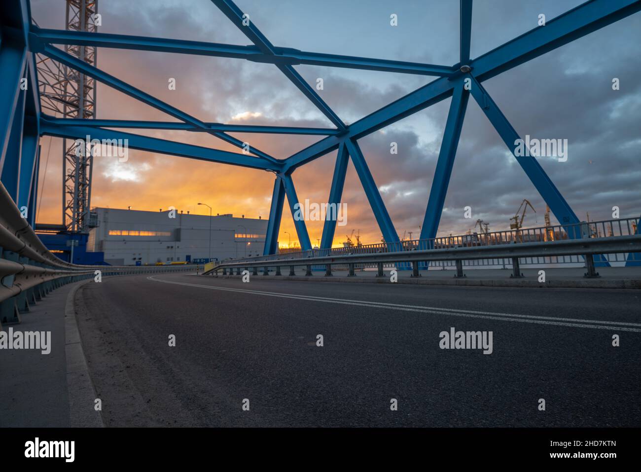 Asphalt road leading through an industrial area,image perfect as a background for 3d rendering Stock Photo