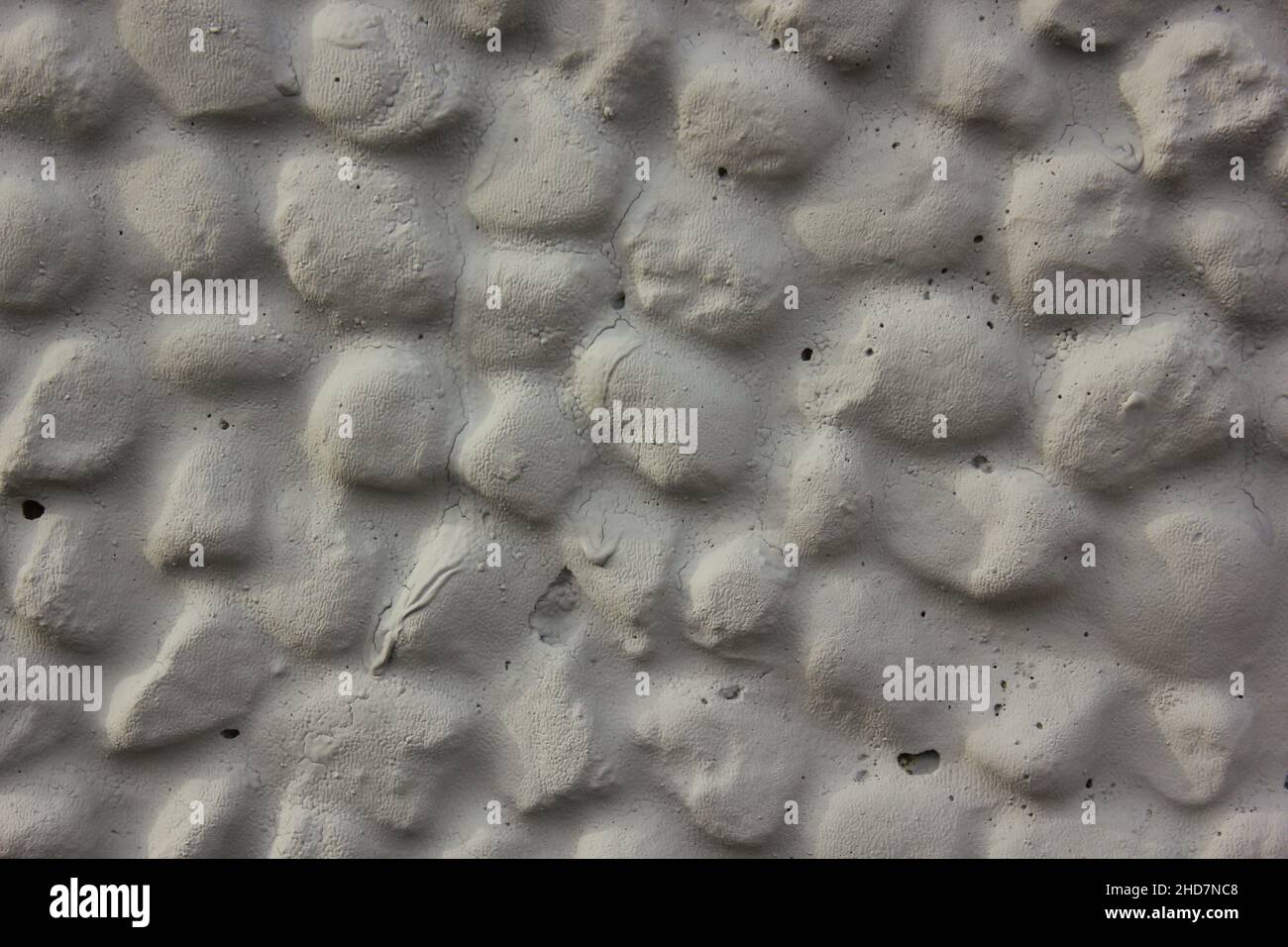 Gravel rock wall painted with grey paint Stock Photo Alamy