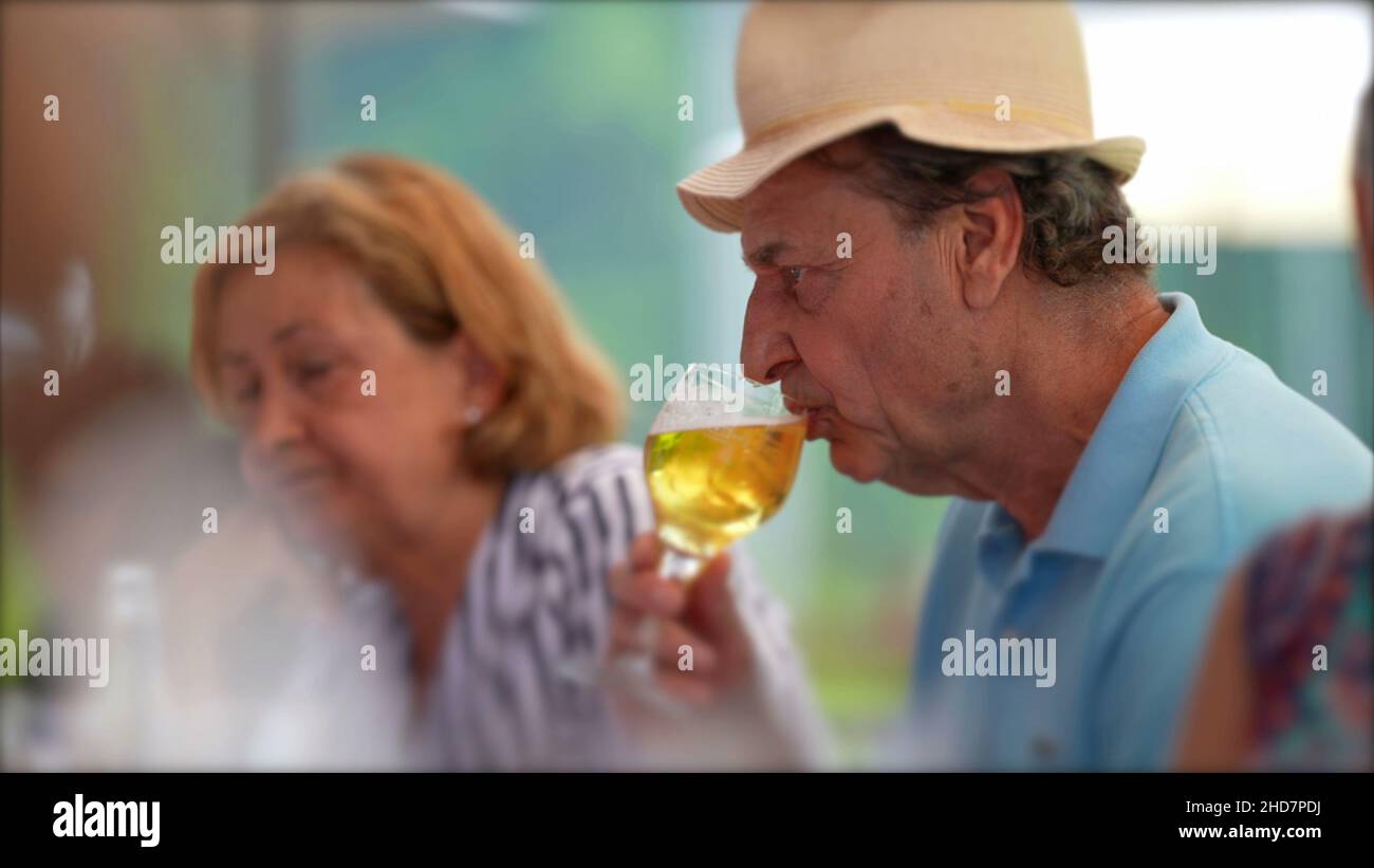 Older man drinking beer candid hi-res stock photography and images - Alamy